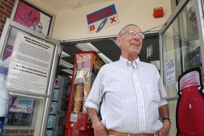 Charlie Lasky stands outside his Thames Street shop in 2009. [Newport Daily News file]
