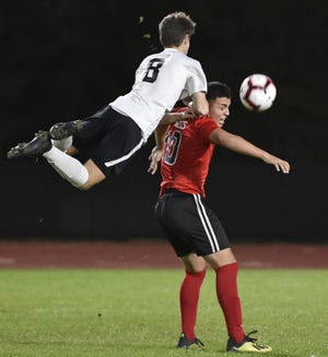 Lakewood Ranch High’s' Jacob Jordan (8) and Palmetto High’s Danny Paniagua battle for the ball during Friday night’s boys soccer match at Harllee Stadium at Palmetto High School. [HERALD-TRIBUNE STAFF PHOTO / THOMAS BENDER]