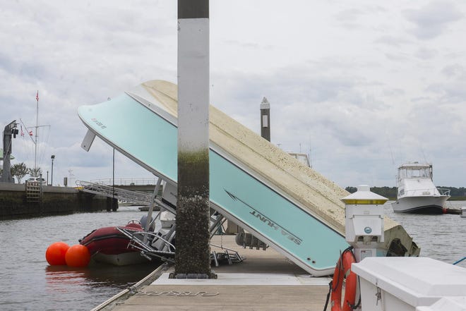 A vessel flipped by a Saturday afternoon tornado rests on the Savannah Yacht Club's dock in May 2019. [Will Peebles/Savannah Morning News]