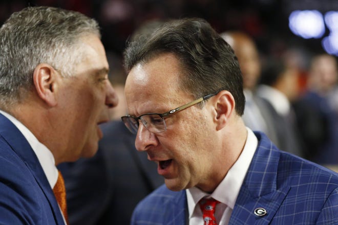 Georgia coach Tom Crean shakes hands with Auburn coach Bruce Pearl before the start of a game between Georgia and Auburn in Athens on Feb. 27, 2019. [JOSHUA L. JONES/ATHENS BANNER-HERALD FILE PHOTO]