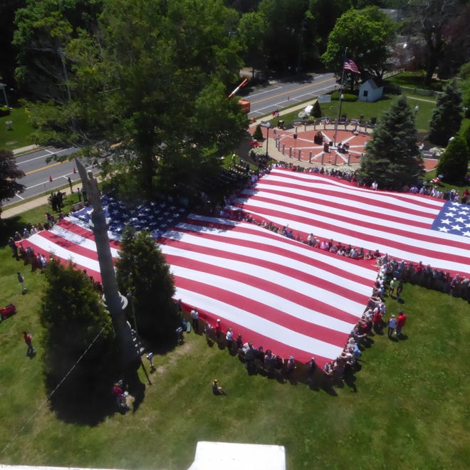 Middleborough's 2019 Veterans Day events highlighted by the display of two large American flags was featured in the December issue of American Legion Magazine. [Photo courtesy of Bob Lessard]