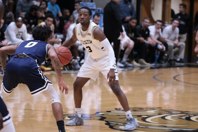 Bryant freshman Michael Green checks his options while being guarded by Mount St. Mary's Vado Morse during Saturday's game in Smithfield. [BRYANT ATHLETICS/ Max Slomiak]
