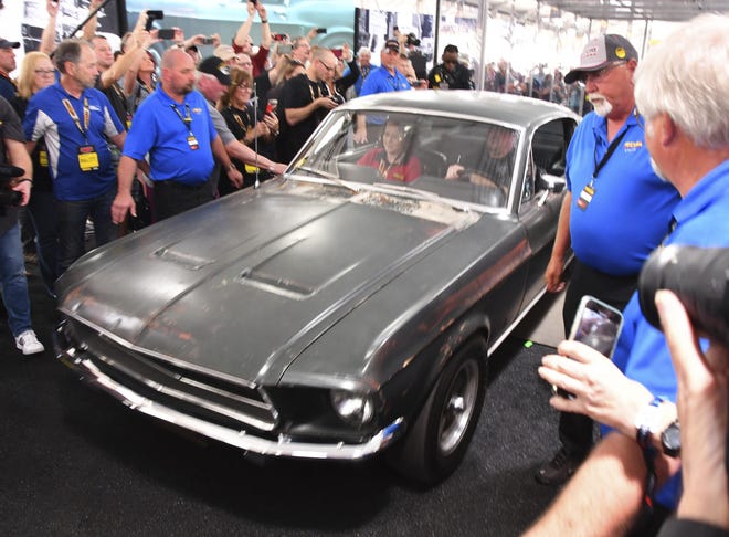 The original 1968 fastback “Bullitt” Mustang GT on its way from the display case to the auction. The classic muscle car sold for $3.4 million at the Mekum auto auction in Kissimmee on Friday. The car had been in the Kiernan family since 1974. [Malcolm Denemark/Florida Today]