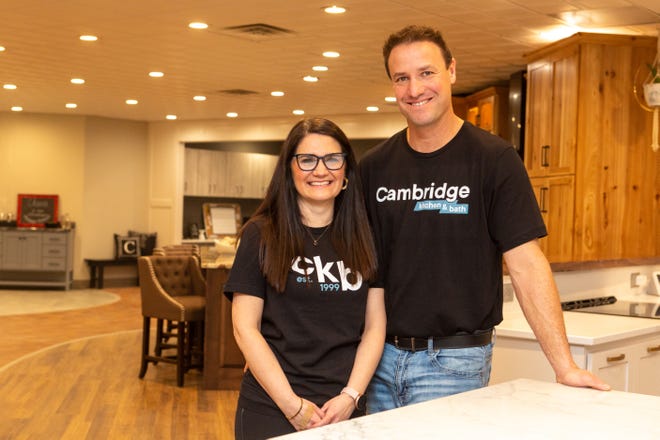 Amber and Zach Leonetti stand in one of the model kitchens of their new Cambridge Kitchen & Bath showroom. They celebrated the grand opening of the showroom Friday. [Evert Nelson/The Capital-Journal]