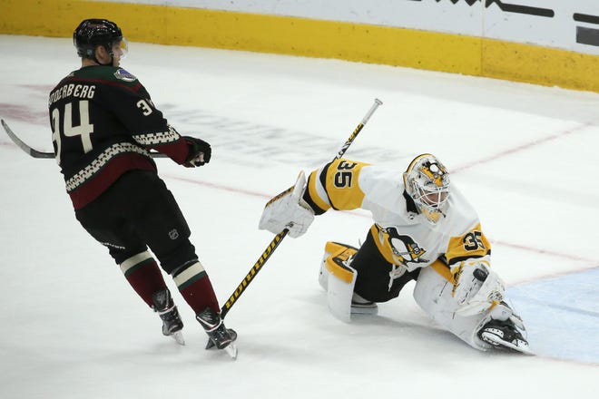 Pittsburgh Penguins goaltender Tristan Jarry (35) makes a save on a shot by Arizona Coyotes center Carl Soderberg (34) during the shootout of an NHL hockey game Sunday, in Glendale, Ariz. The Penguins defeated the Coyotes 4-3. [ROSS D. FRANKLIN/THE ASSOCIATED PRESS]