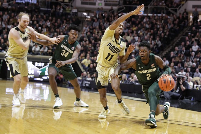 Michigan State guard Rocket Watts (2) drives on Purdue guard Isaiah Thompson (11) during the first half of an NCAA college basketball game in West Lafayette, Ind., Sunday, Jan. 12, 2020. (AP Photo/Michael Conroy)