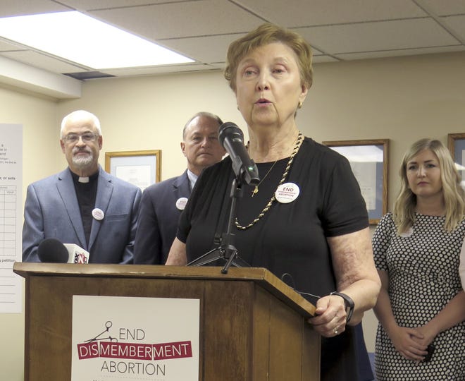 In this June 26, 2019, file photo, Barbara Listing, president of Right to Life of Michigan, joins other anti-abortion advocates to officially launch a ballot drive to restrict a common second-trimester abortion procedure opponents call "dismemberment," and known medically as dilation and evacuation, during a news conference in Lansing, Mich. A ballot group planned Monday, Dec. 23, 2019, to submit petitions to prohibit a second-trimester abortion procedure in Michigan, a key step toward placing the veto-proof legislation before the Republican-controlled Legislature. (AP Photo/David Eggert, File)