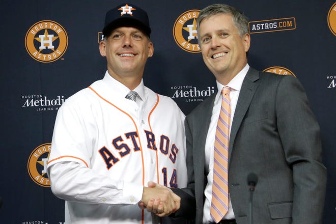 FILE - In this Sept. 29, 2014, file photo, Houston Astros general manager Jeff Luhnow, right, and A.J. Hinch pose after Hinch is introduced as the new manager of the baseball club in Houston. Hinch and Luhnow were fired Monday, Jan. 13, 2020, after being suspended for their roles in the team's extensive sign-stealing scheme from 2017. (AP Photo/Pat Sullivan, File)