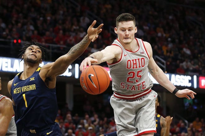 Ohio State's Kyle Young (25) grabs a rebound against West Virginia's Derek Culver (1) during the second half of an NCAA college basketball game Sunday, Dec. 29, 2019, in Cleveland. [Ron Schwane/The Associated Press]