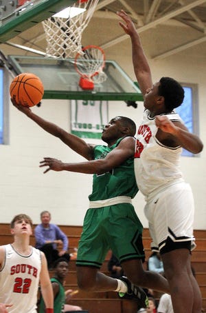 Ashbrook's Shemar Adams drives to the basket as South Mecklenburg's Bo Davidson defends during their game in the 3rd Annual Ashbrook Holiday Hoopfest Thursday afternoon at Ashbrook High School. [JOHN CLARK/THE GASTON GAZETTE]