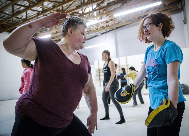 Shaay Gallagher-Starr and her daughter, Ananda Gallagher-Starr, practice palm strikes and slapping together at the Warrior Sisters self-defense class. [Dana Sparks/The Register-Guard] - registerguard.com