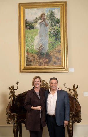 Lightner Museum Board of Trustees Chair Teresa Radzinski and Jacksonville arts patron David Gonzales with the painting “Return of Persephone” (1906). [CONTRIBUTED]