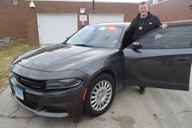 Detective Sgt. Josh Verscheure shows off the new investigator's car, one of six Dodge Chargers the sheriff's department purchased last year with the proceeds of the public safety sales tax.