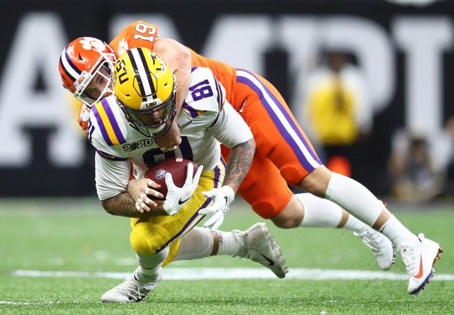 Jan 13, 2020; New Orleans, Louisiana, USA; LSU Tigers tight end Thaddeus Moss (81) is tackled by Clemson Tigers safety Tanner Muse (19) in the fourth quarter in the College Football Playoff national championship game at Mercedes-Benz Superdome. (Mark J. Rebilas-USA TODAY Sports)