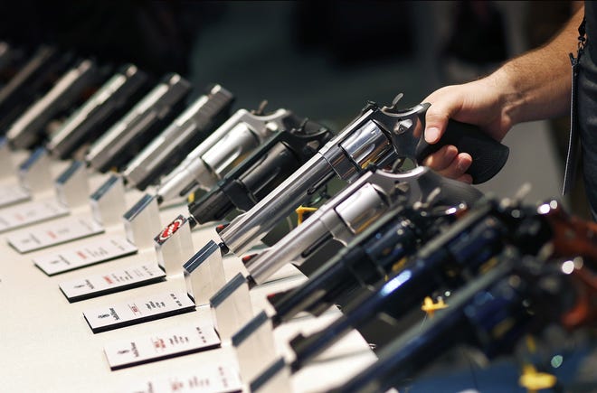 In this Jan. 19, 2016, photo, handguns are displayed at the Smith & Wesson booth at the Shooting, Hunting and Outdoor Trade Show in Las Vegas. [AP Photo/John Locher, File]