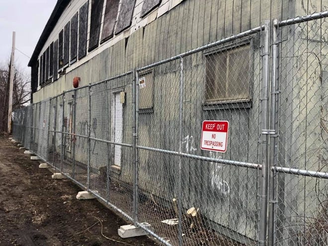 The Highway Department put a fence around the collapsing building at 72 Depot St. [Courtesy photo/Milford Highway Department]