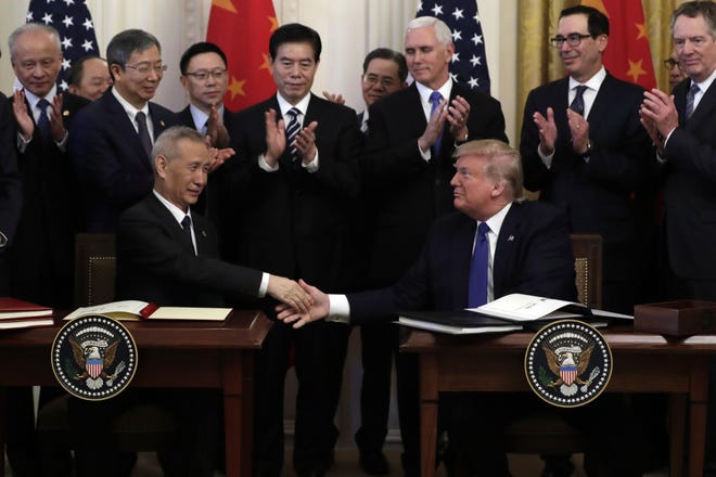 President Donald Trump and Chinese Vice Premier Liu He sign “Phase One” of a US-China trade agreement on Wednesday in the East Room of the White House. “We mark more than just an agreement. We mark a sea change in international trade,” Trump said. [AP photo / Evan Vucci]