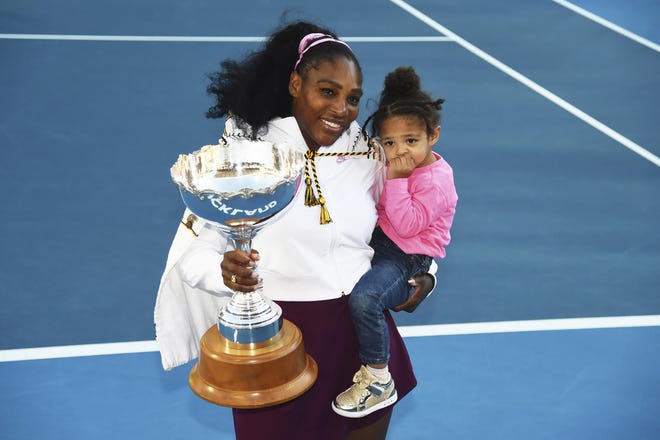 Serena Williams with daughter Alexis Olympia Ohanian Jr. and the ASB trophy after winning her singles finals match against Jessica Pegula of the U.S. at the ASB Classic in Auckland, New Zealand, Sunday. [Chris Symes/Photosport via AP]