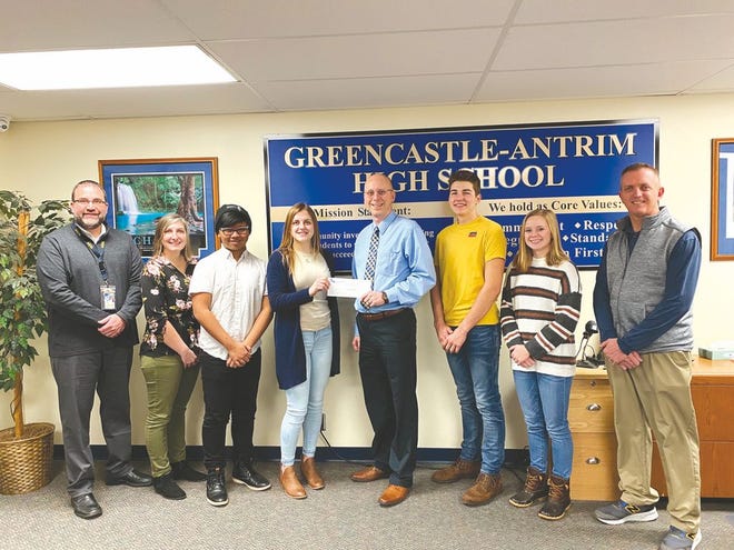 Representatives of the Greencastle-Antrim High School Student Council Executive Committee and administrators were on hand Monday to present a check for $835.56 from the Holiday Door Contest to Shaun Basalik, president of the Exchange Club of Greencastle. From left: Principal Dr. Ed Rife, student council adviser Glory Sterling, Lio Salazar, Madi Kirkwood, Shaun Basalik, Logan Diller, Micaela Dougherty and Gerald Crable, assistant principal. SHAWN HARDY/ECHO PILOT