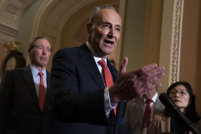 Senate Minority Leader Chuck Schumer, D-N.Y., joined at left by Sen. Tom Udall, D-N.M., meets with reporters as the House prepares to send the articles of impeachment against President Donald Trump to the Senate, at the Capitol in Washington, Tuesday, Jan. 14, 2020. (AP Photo/J. Scott Applewhite)