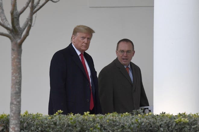 President Donald Trump, left, and acting White House chief of staff Mick Mulvaney, right, walk along the colonnade of the White House in Washington, Monday, Jan. 13, 2020. Trump is heading to New Orleans, to attend the College Football Playoff National Championship between Louisiana State University and Clemson. (AP Photo/Susan Walsh)