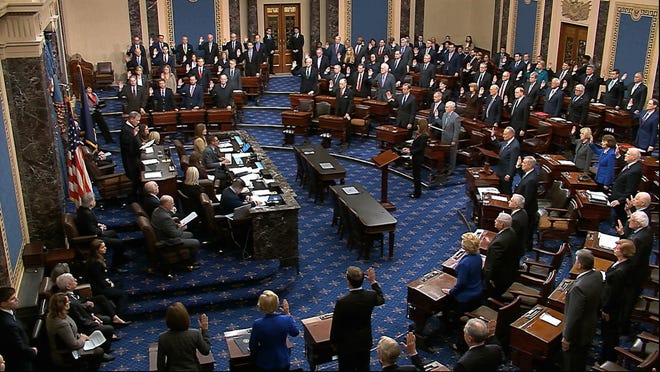 In this image from video, presiding officer Supreme Court Chief Justice John Roberts swears in members of the Senate for the impeachment trial against President Donald Trump at the U.S. Capitol in Washington Thursday. (Senate Television via AP)