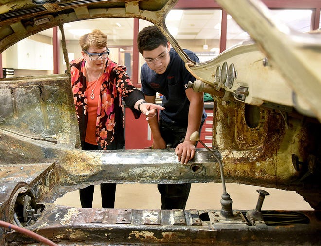File- Department of Labor and Industry Deputy Secretary for Workforce Development Eileen Cipriani looks over the auto body work that Upper Bucks County Technical School student Dylan Augustin is doing on a car Thursday, May 18, 2018. Cipriani visited the school as part of Gov. Tom Wolf's PAsmart proposal to prepare students with the education and job skills that local employers need. [ART GENTILE / PHOTOJOURNALIST]
