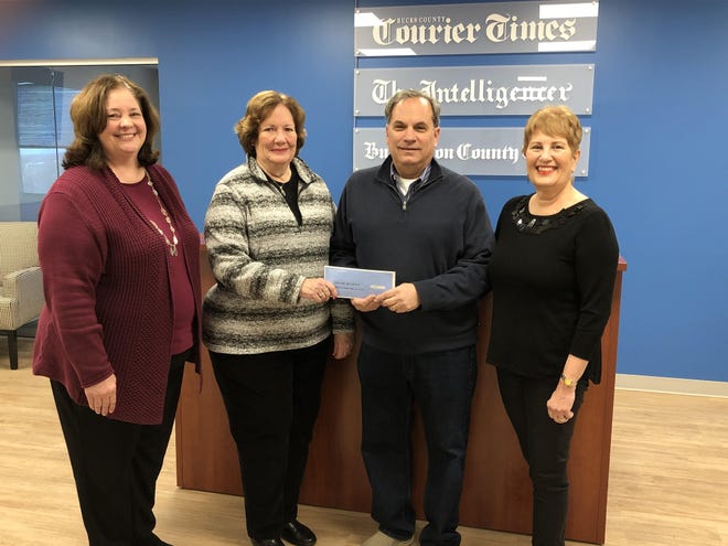 From left, Jill Saul, president of the Levittown-Bristol Kiwanis, and Mary Berman of the Kiwanis, accept a $1,166 donation from Cliff Davis, treasurer of the social committee of the Regency at Yardley community in Lower Makefield, and Renee Wolfson, chair of the social committee, at the offices of the Bucks County Courier Times in Middletown. Residents of the 55-and-older community raised the funds for the Courier Times and Kiwanis’ Give A Christmas campaign during a New Year’s Day Polar Plunge. [CRISSA SHOEMAKER DEBREE / STAFF PHOTOJOURNALIST]