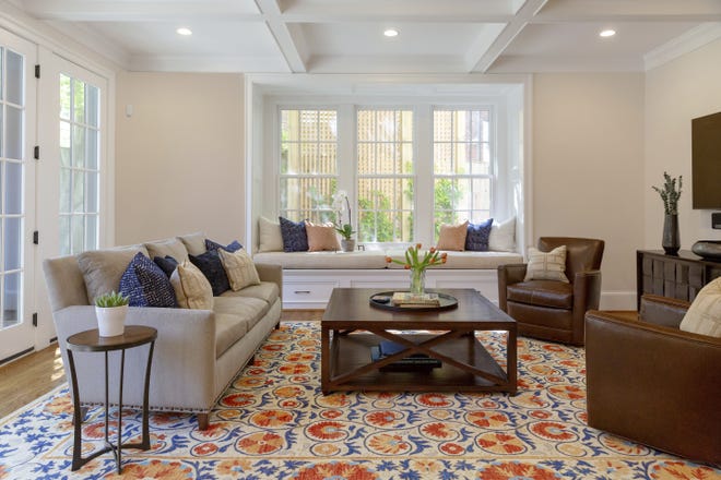 This photo shows a room design by designer Jessica Wachtel. If you're seeking to brighten up a room during the dark winter months, Wachtel suggests adding a patterned rug in light and bright colors, as she did in this Bethesda, Md., living room. [Joe Cereghino/Jessica Wachtel via AP]