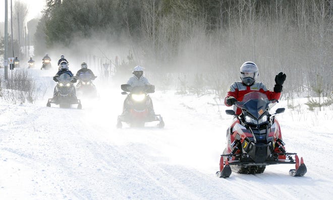 Michigan Department of Natural Resources conservation officers — joined by local, state and federal officers — will be conducting group patrols to help make sure snowmobilers "Ride Right" during the holiday weekend. File photo