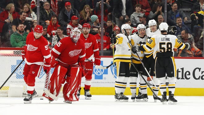Pittsburgh Penguins center Sidney Crosby, third from right, celebrates his winning goal against the Detroit Red Wings in overtime of an NHL hockey game Friday, Jan. 17, 2020, in Detroit. (AP Photo/Paul Sancya)