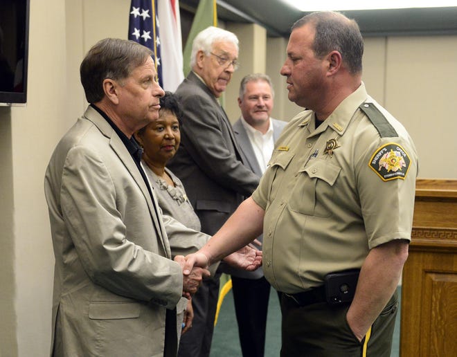 Gadsden mayor Sherman Guyton, left, and Etowah County Sheriff Jonathon Horton, right, shake hands following a press conference about the housing of city inmates at the county jail in 2019. [File/Gadsden Times]
