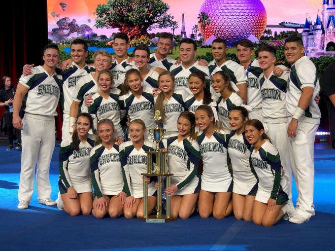 Members of the Shelton State Community College cheerleading squad pose with the national championship trophy from the Universal Cheerleaders Association competition in Orlando, Florida. [Photo by Shelton State Community College]