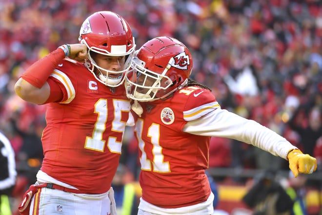 The Kansas City Chiefs' Patrick Mahomes (15) celebrates with Demarcus Robinson after running for a touchdown during the first half of the AFC Championship game Sunday in Kansas City, Missouri. [Ed Zurga / Associated Press]