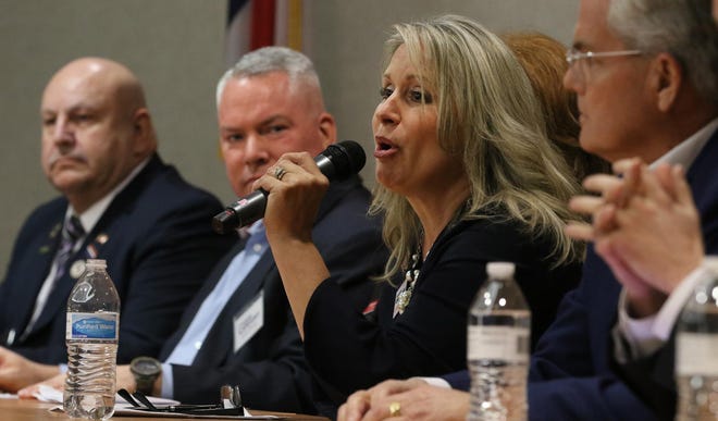 Renee Ellmers, running for lieutenant governor, answers a question during Saturday’s 2020 Statewide Republican Candidates Forum held in the auditorium at the Gaston County Department of Social Services in Gastonia. At left is Ron Pierce, a candidate for Commissioner of Insurance, and Greg Campbell, who was representing lieutenant governor candidate Greg Gebhardt. At right is Andy wells, another candidate for lieutenant governor. [Mike Hensdill/The Gaston Gazette]