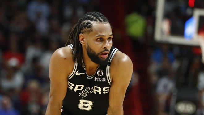 San Antonio Spurs guard Patty Mills rests during a game Wednesday in Miami. [Brynn Anderson/The Associated Press]