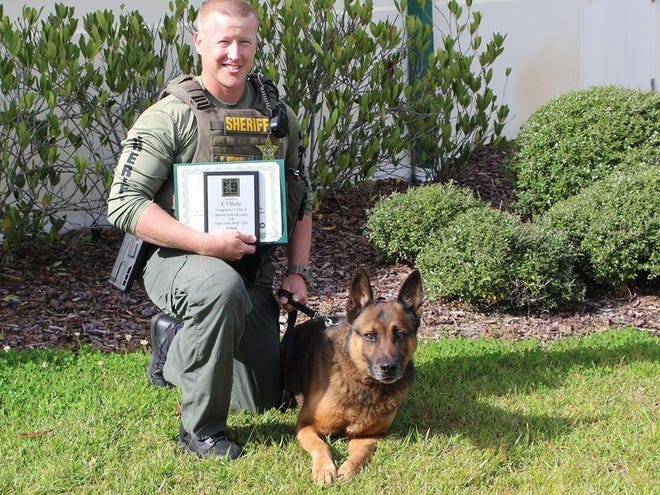 Flagler County Sheriff's Office Cpl. Fred Gimbel and K-9 Marko pose for a photo during Marko's retirement ceremony on Thursday, Jan. 16, 2020. [Provided photo/FCSO]