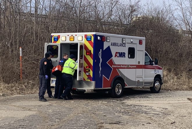 American Medical Response ambulance crews respond Monday morning to a report of a man suffering from frostnip and hypothermia beneath an Interstate 70 overpass on the southeast edge of downtown Topeka. [Phil Anderson/The Capital-Journal]
