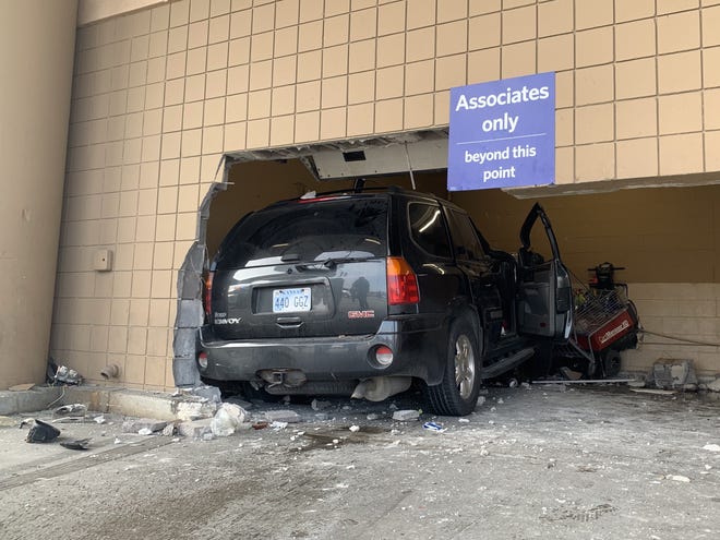 A GMC Envoy sport utility vehicle appeared to have struck several parked vehicles before it went through an exterior wall early Monday afternoon at Sam's Club, 1401 S.W. Wanamaker. [Phil Anderson/The Capital-Journal]