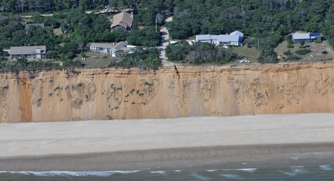 The town of Eastham is working with the National Park Service to relocate a quarter-mile of Nauset Light Beach Road, at top of photo, away from the shoreline because of ongoing erosion. One home on the road was declared unsafe in March 2018 because of the crumbling shoreline. [Steve Heaslip/Cape Cod Times file]