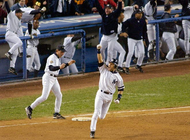 FIEE - In this Oct. 31, 2001, file photo, New York Yankees' Derek Jeter celebrates his game-winning home run in the 10th inning as he rounds first base in Game 4 of baseball's World Series against the Arizona Diamondbacks at Yankee Stadium in New York. Jeter could be a unanimous pick when Baseball Hall of Fame voting is announced Tuesday, Jan. 21, 2020. (AP Photo/Bill Kostroun, File)