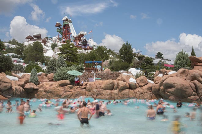 Guests splash around in the one-acre wave pool, Melt-Away Bay, at Disney's Blizzard Beach Water Park. Themed as a former ski resort that has now melted into a watery wonderland, Disney's Blizzard Beach Water Park has exciting watersides, family-style raft rides, a lazy river and much more. Disney's Blizzard Beach Water Park is one of two water parks at Walt Disney World Resort in Lake Buena Vista, Fla. [Preston Mack, photographer]