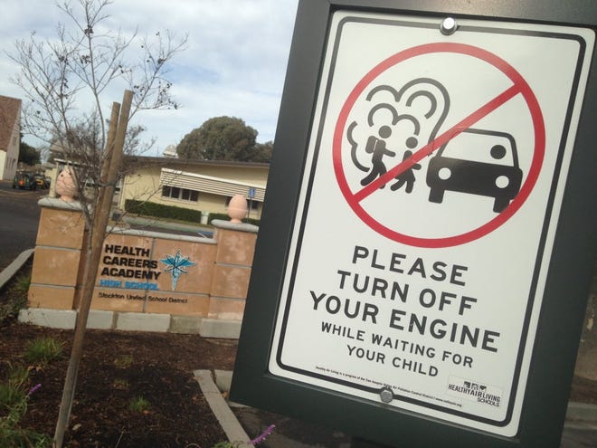 Signs encouraging drivers not to idle their vehicles have been posted outside the Health Careers Academy in central Stockton, part of a program to reduce the impacts of air pollution on vulnerable youngsters. [ALEX BREITLER/RECORD FILE 2015]