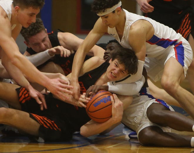Churchill players swarm Crater star Nate Bittle as he battles for possession in overtime. [Chris Pietsch/The Register-Guard] - registerguard.com