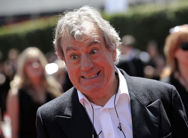 In this Saturday, Aug. 21, 2010 file photo, Terry Jones arrives at the Creative Arts Emmy Awards in Los Angeles. Terry Jones, a member of the Monty Python comedy troupe, has died at 77. Jones's agent says he died Tuesday Jan. 21, 2020. In a statement, his family said he died “after a long, extremely brave but always good humored battle with a rare form of dementia, FTD.” (AP Photo/Chris Pizzello)