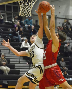 Corning’s Landen Burch and Owego’s Nick Wasyln fight for a rebound Wednesday. [TOM PASSMORE/THE LEADER]