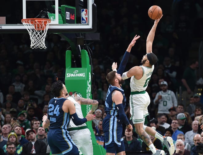 Celtics forward Jayson Tatum shoots the ball over Memphis center Jonas Valanciunas during the second half Wednesday night in Boston. [USA Today Sports / Bob DeChiara]