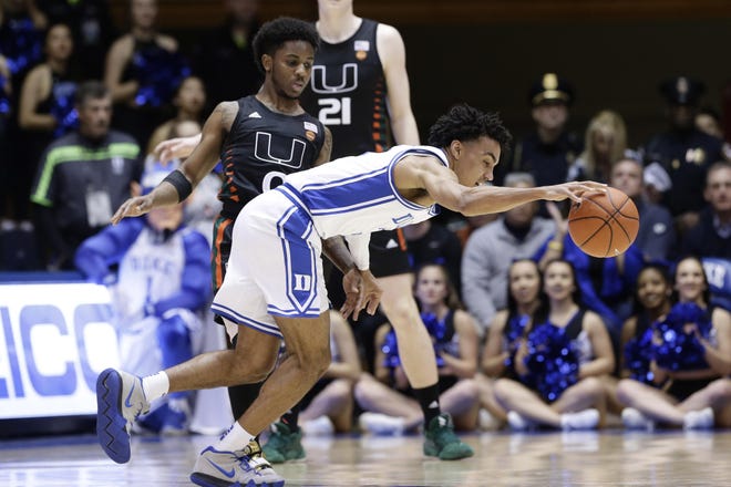 Miami’s Chris Lykes guards Duke’s Tre Jones during the first half Tuesday in Durham, N.C. [Gerry Broome/The Associated Press]