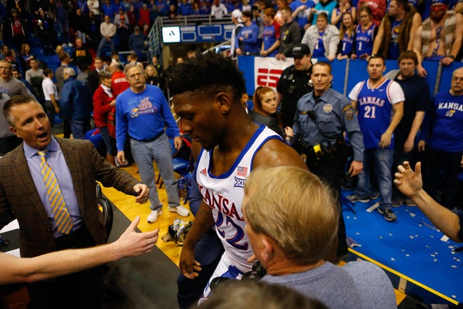 Kansas basketball forward Silvio De Sousa leaves the court after participating in a brawl with several Kansas State players in the final seconds of the No. 3-ranked Jayhawks' 81-60 victory Tuesday at Allen Fieldhouse in Lawrence. De Sousa threw punches and wielded a metal stool during the approximately 35-second altercation. [Evert Nelson/The Capital-Journal]