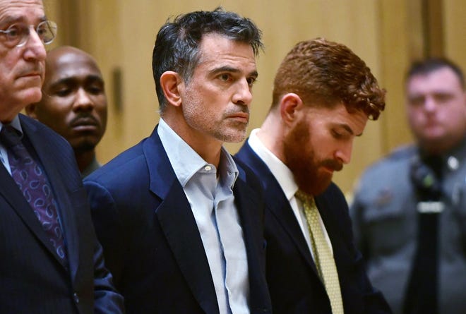 In this Jan. 8, 2020 file photo, Fotis Dulos, the estranged husband of a missing mother of five who is presumed dead, is arraigned on murder and kidnapping charges in Stamford Superior Court, in Stamford, Conn. According to a state prosecutor, Dulos violated the terms of his release on $6 million bond because he was seen removing items from a memorial for his wife set up near his home. Stamford State’s Attorney Richard Colangelo filed a court document Wednesday, Jan. 22 asking a judge to modify the bond for Dulos. (Erik Trautmann/Hearst Connecticut Media via AP, Pool)